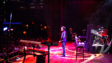 Apollo Riego looking out at a sold-out crowd during a live magic performance at House of Blues Atlantic City