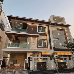 Modern house elevation with exterior lighting and balcony design in Vikarabad Hyderabad by Epikaizo Constructions