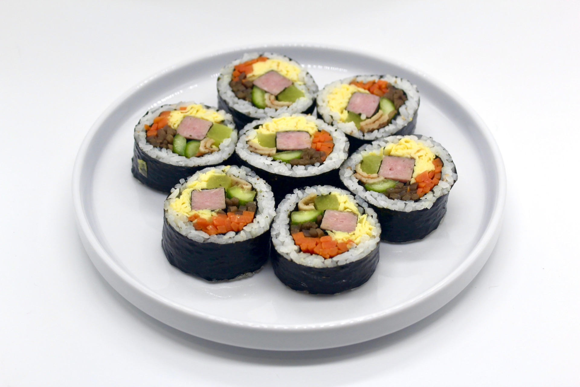 Official photograph of freshly sliced classic kimbap rolls from K-Kimbap in Chinatown