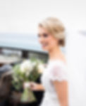 Beautiful smile of the bride holding wedding bouquet