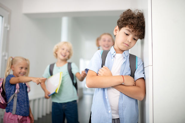 sad-boy-leaning-on-wall-while-children-laugh-2026-03-09-23-09-36-utc.jpg