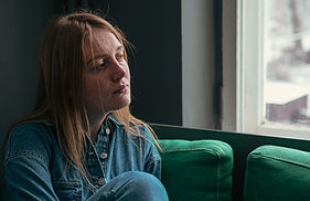 contemplative-woman-sits-near-window-in-denim-shir-2026-03-25-00-02-44-utc.jpg