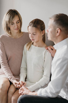 parents-daughter-praying-together-home.jpg