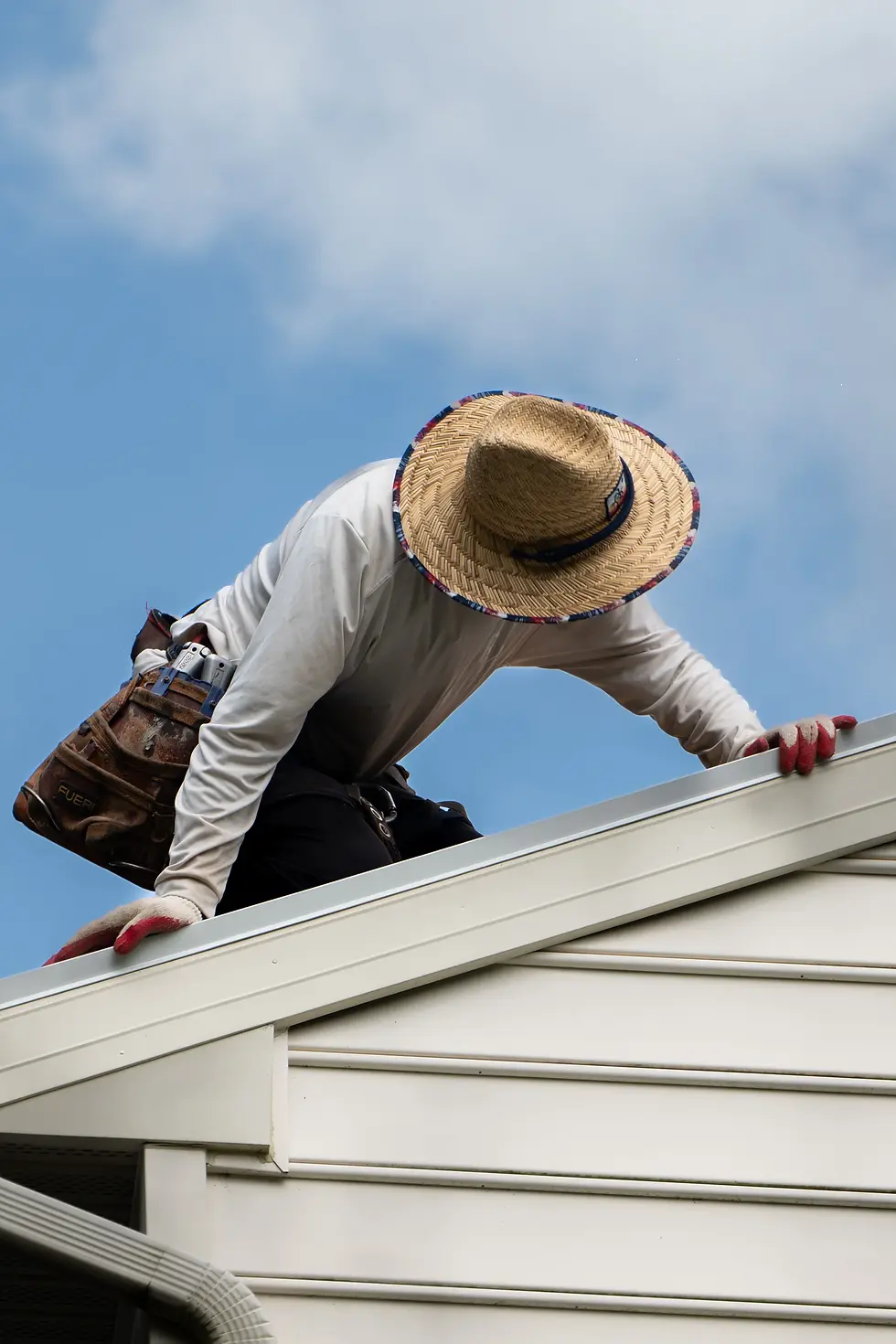 Photo man on roof checking is roof replacement tax deductible