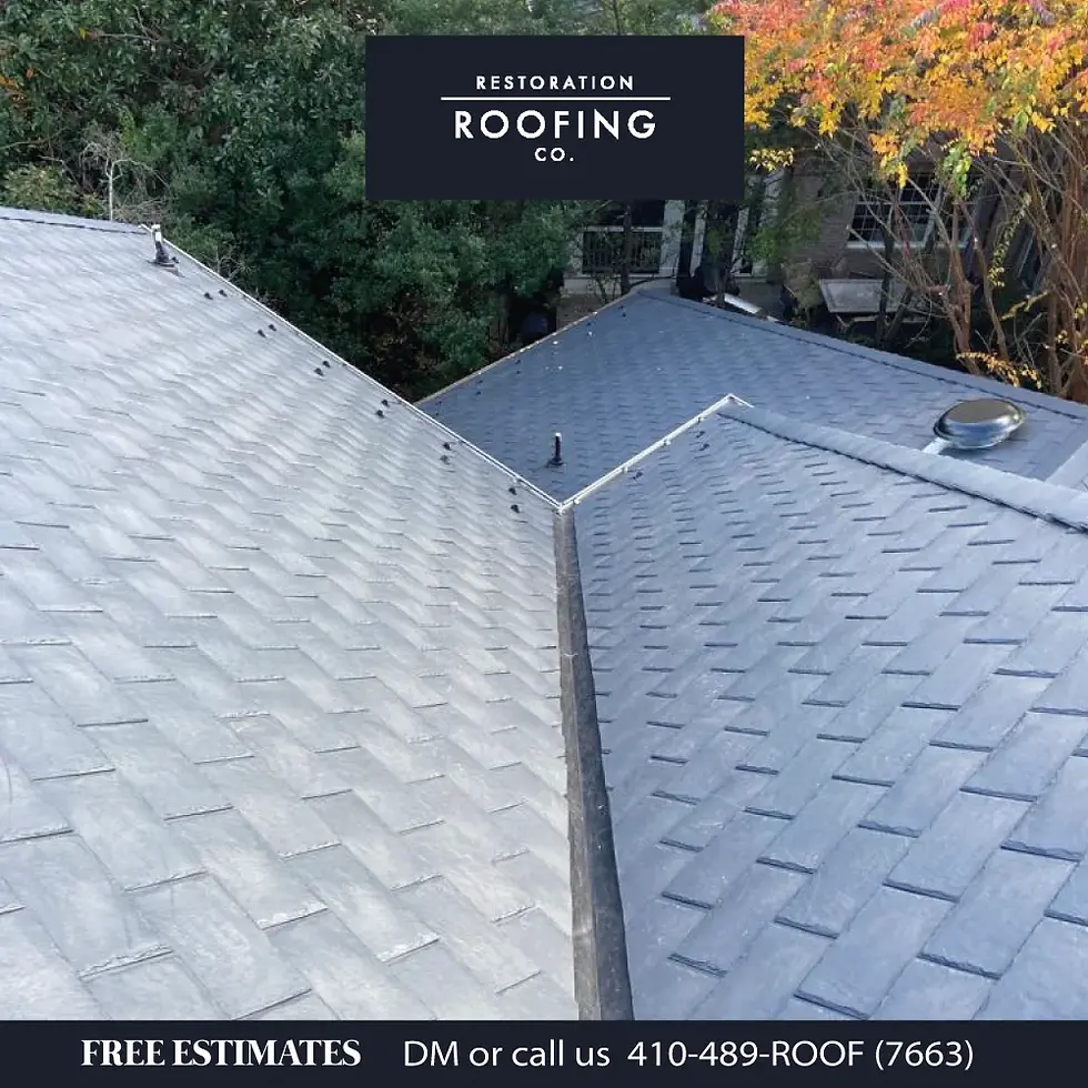 Close up view of gray shingle roof with clean valley detail metal vent and trees in background showing roofing basics and quality installation.