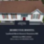 White house with Burnt Sienna shingle roof and red door promoting residential roofing services by Restoration Roofing in Taneytown, MD.