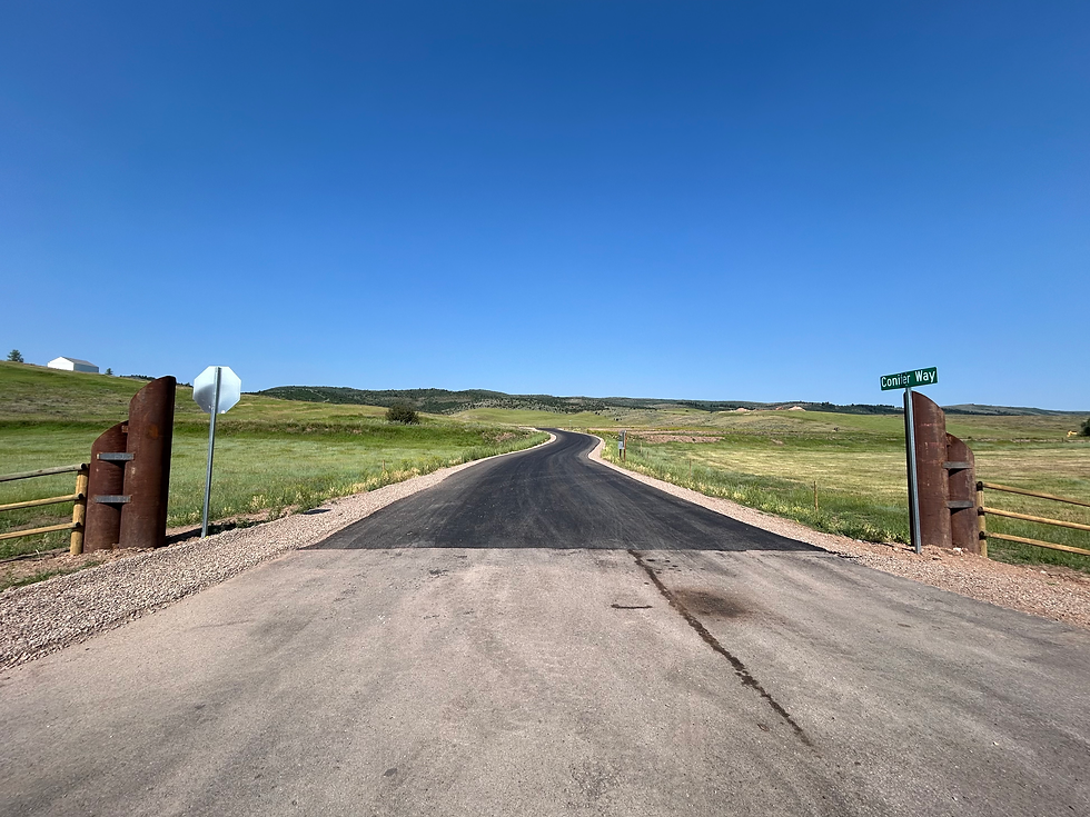 Image of the newly paved road and entrance to Painted Hills Subdivision in Afton, WY.