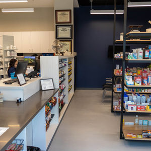 Modern pharmacy with custom metal shelves.