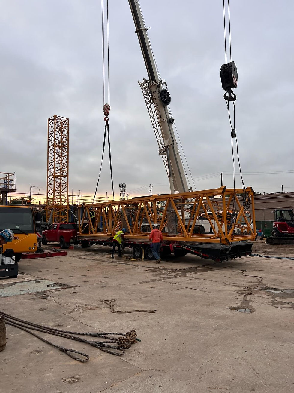 Construction crane section being loaded onto trailer.