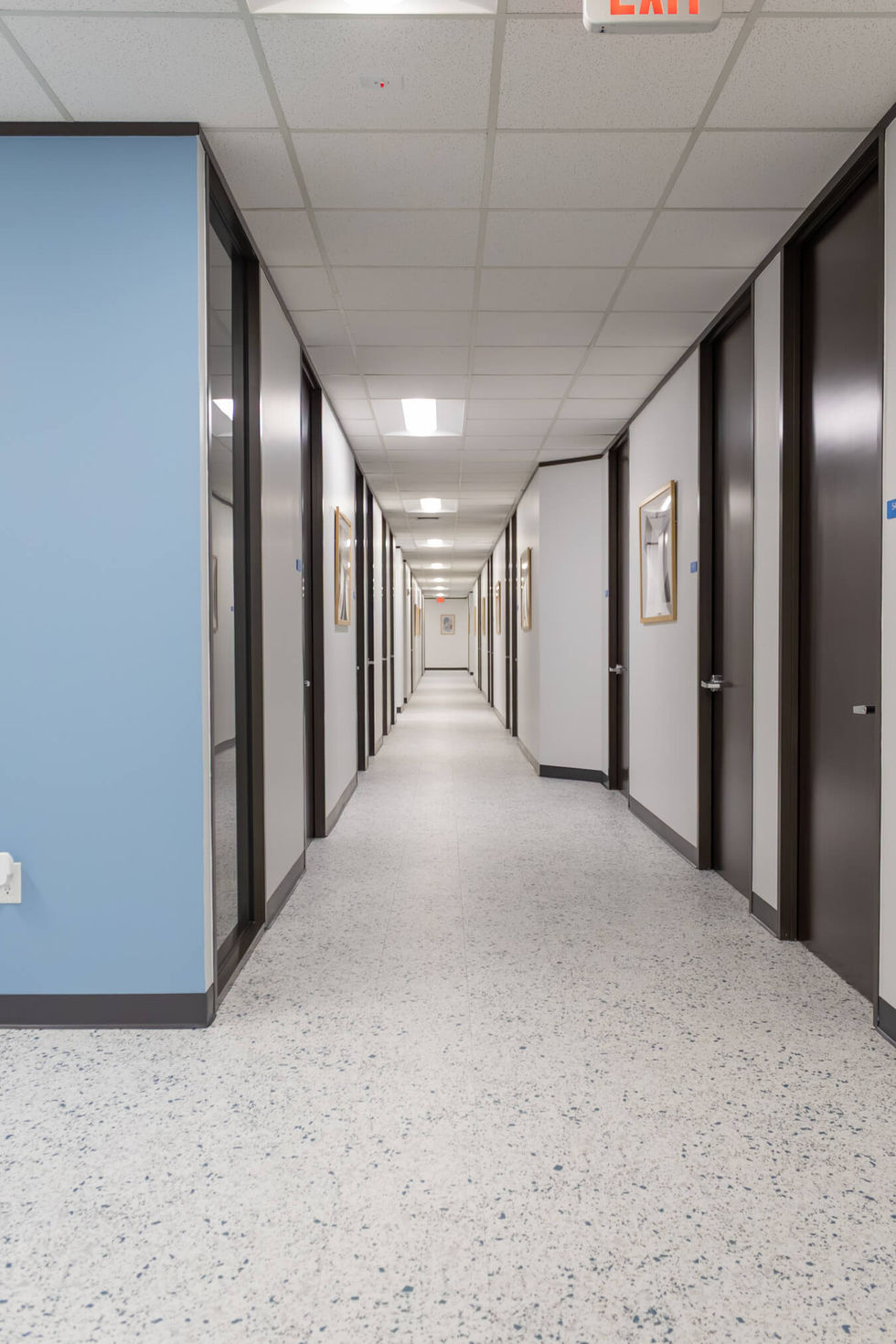 Modern white office hallway with long tilework