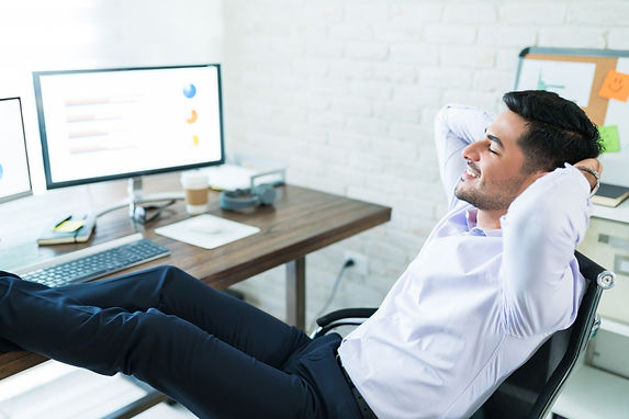 contented-businessman-relaxing-with-hands-head-desk-while-working-from-home.jpg