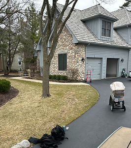 Exterior view of a home with a driveway and garage, daytime scene