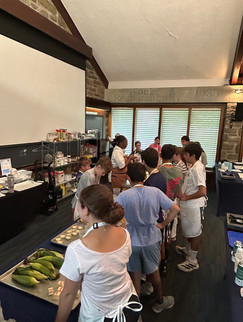 Junior chefs listen to a demo with Chef Carisa.