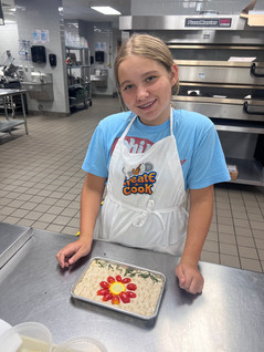 A junior chefs works on her summer garden focaccia.