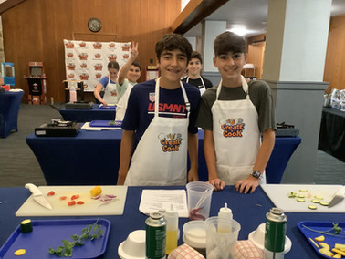 Junior chefs pose for a picture between their knife skills.