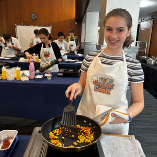 Another Junior Chef sautés her ingredients.