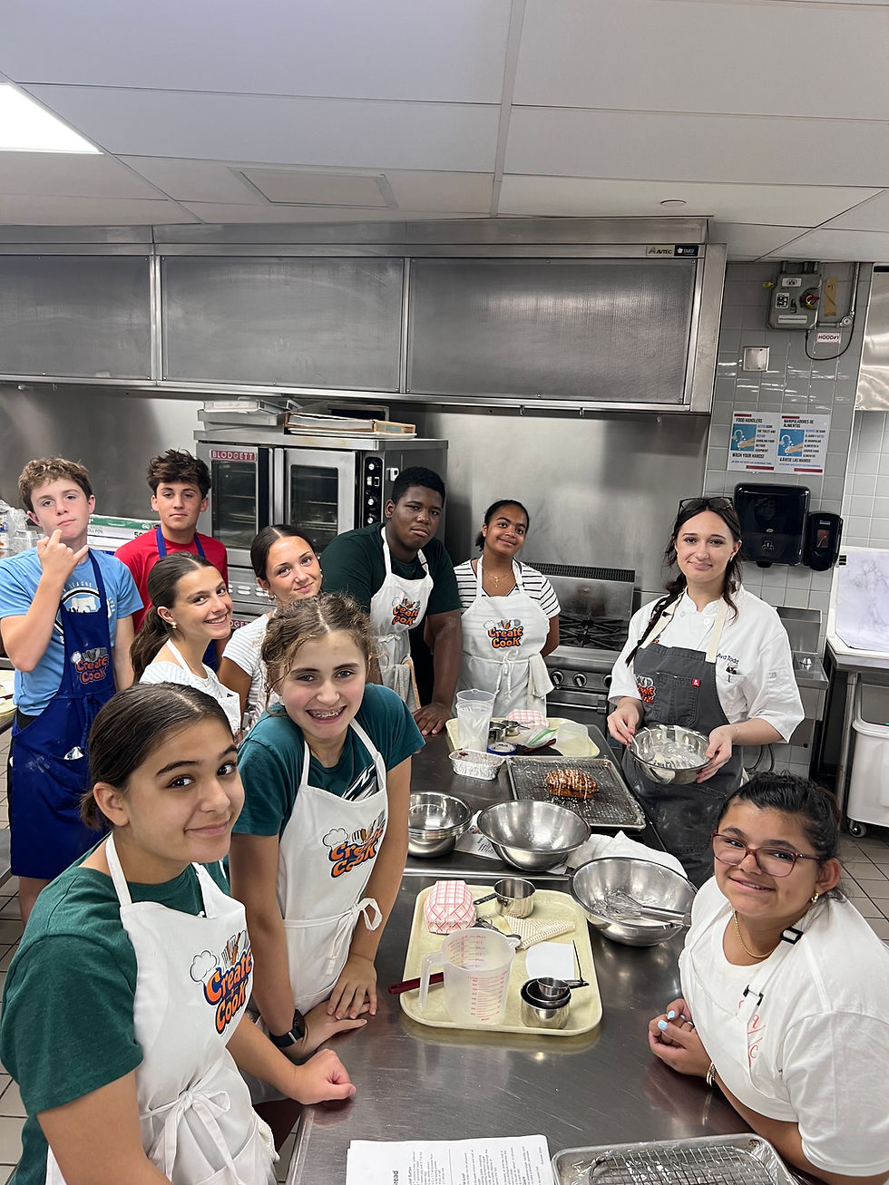 The baking and pastry side stops to snap a picture with Instructor Ava.