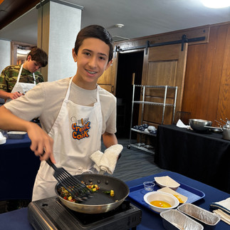 A junior chef sautés ingredients for today's recipe!