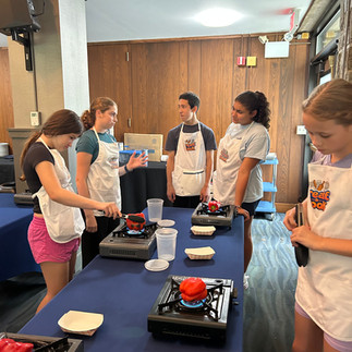 Junior chefs patiently wait for red peppers to roast.
