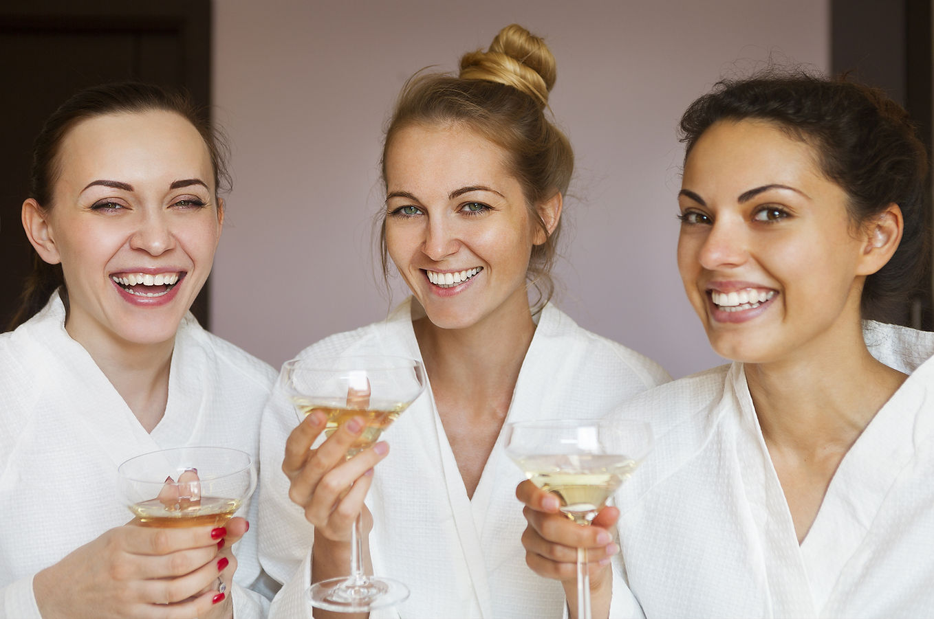 three young women at spa party with champagne