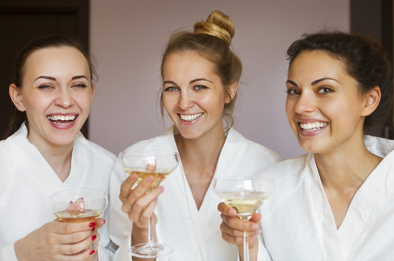 three young women at spa party with champagne