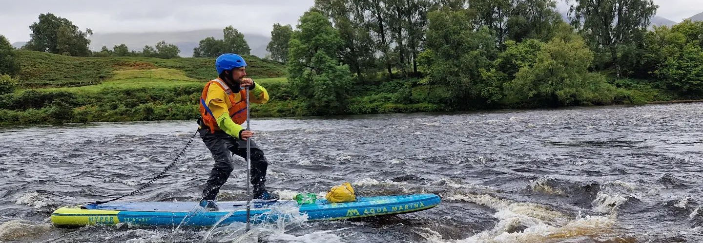 paddle boarder next to whirl pool