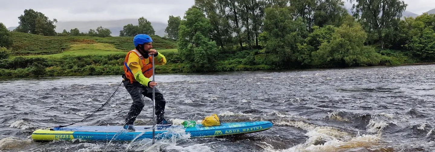 paddle boarder next to whirl pool