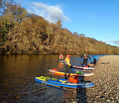 paddleboarders on the river lochy