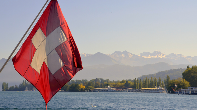 Swiss flag with Lucerne lake on its background