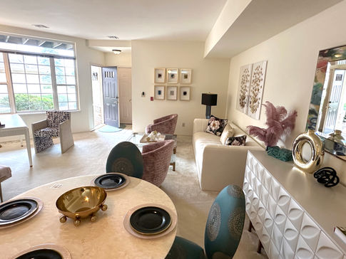 Updated living room at Springbrook Cercle featuring new flooring, fresh paint, and modern design touches.