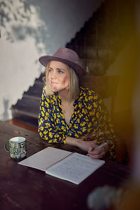 Women writing in a journal looking hopeful
