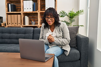 Young latina woman counselor having online therapy session at therapy office.jpg