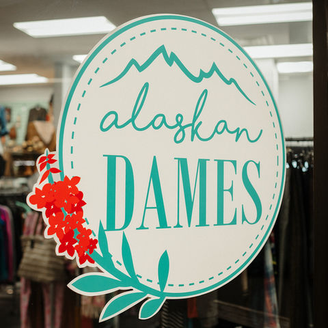 Alaskan Dames logo and branding by Z Squared Studio on a window.