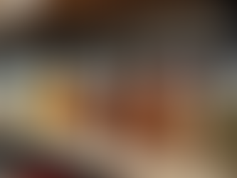 Various seasoning jars lined up on a kitchen shelf