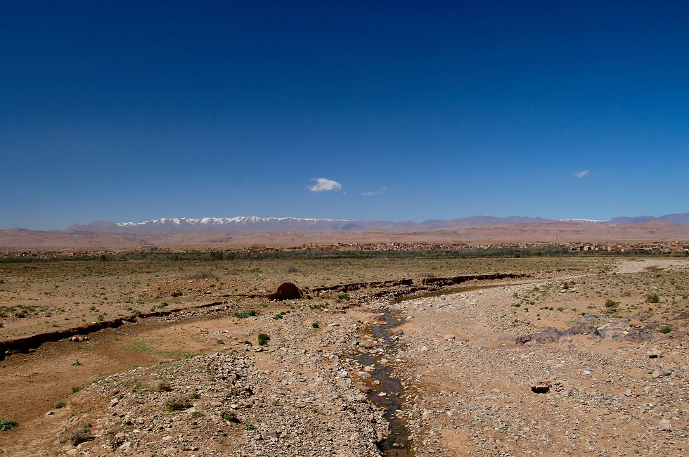 Dramatic desert scenery near Ouarzazate backed by the snow-capped Atlas Mountains