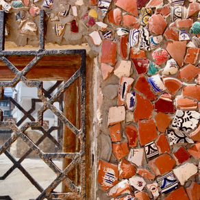Broken ceramics decorate a wall in Agadir, Morocco