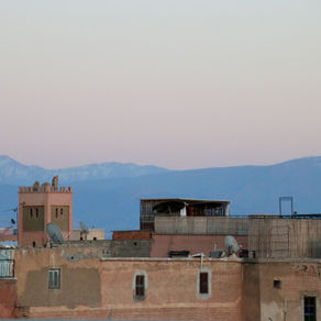 Snow on the Atlas Mountains behind the rooftops of Marrakech