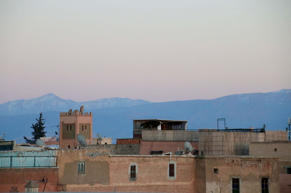 Views across the rooftops of Marrakech toward the snow-capped Atlas Mountains