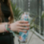 A woman filling a reusable water bottle