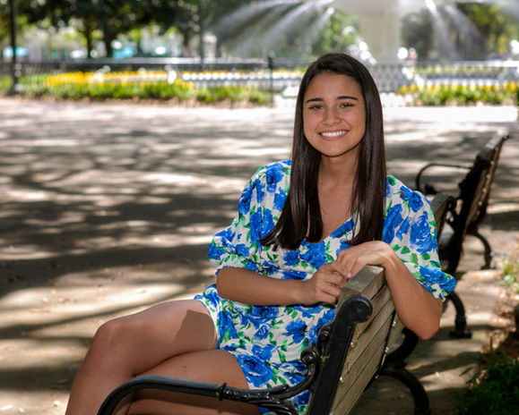 high school senior sitting on bench in front of forsyth park downtown savannah fountain_ P