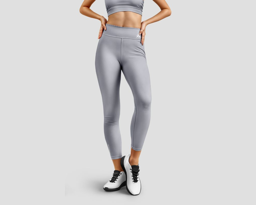 Woman in gray leggings and white shoes