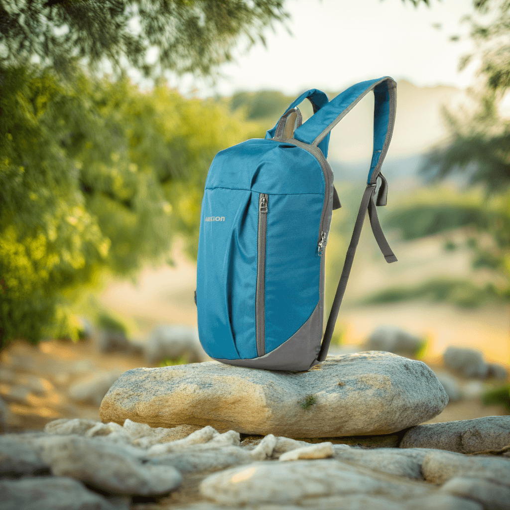 Blue backpack on rocks outdoors