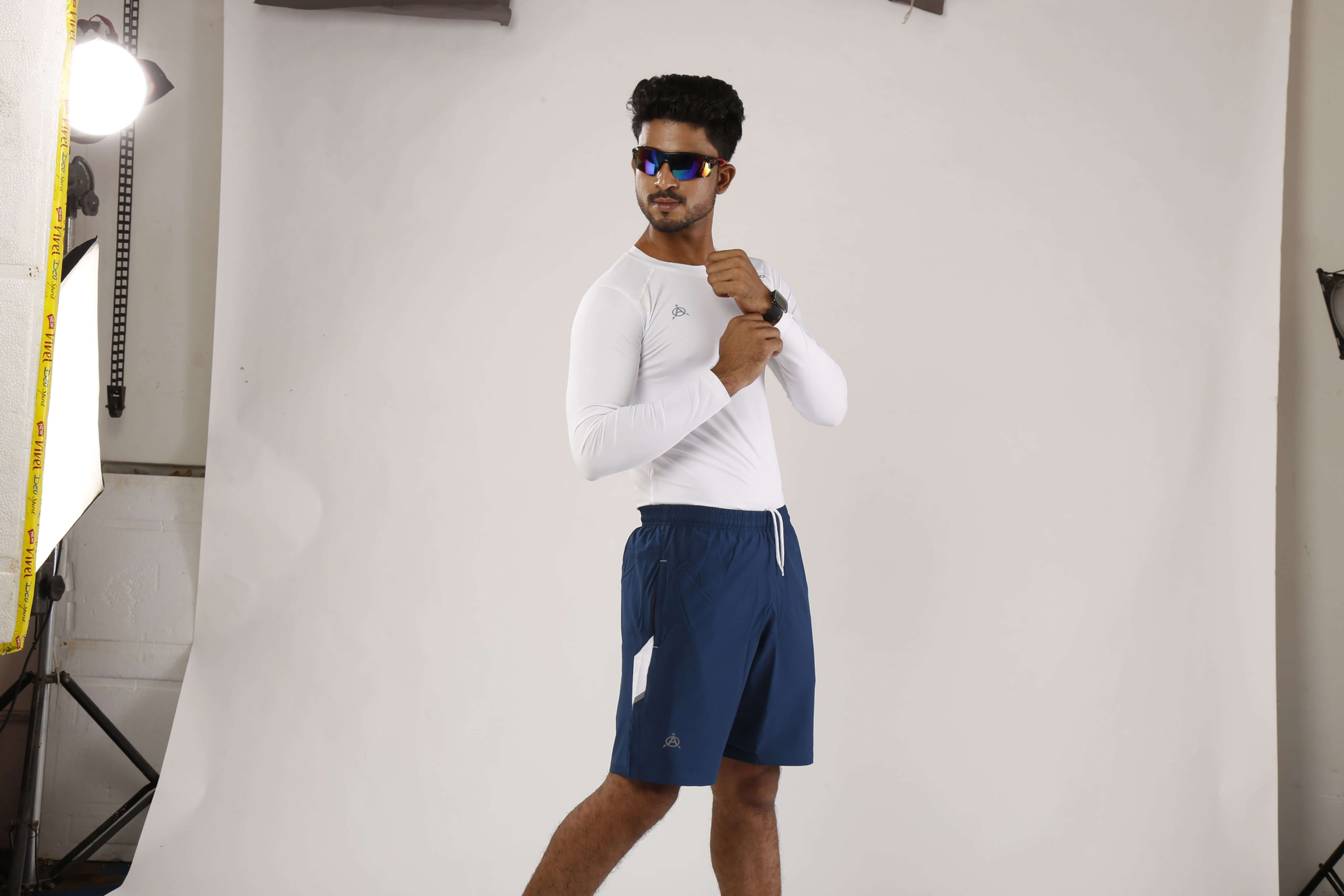 Man in white shirt and navy shorts