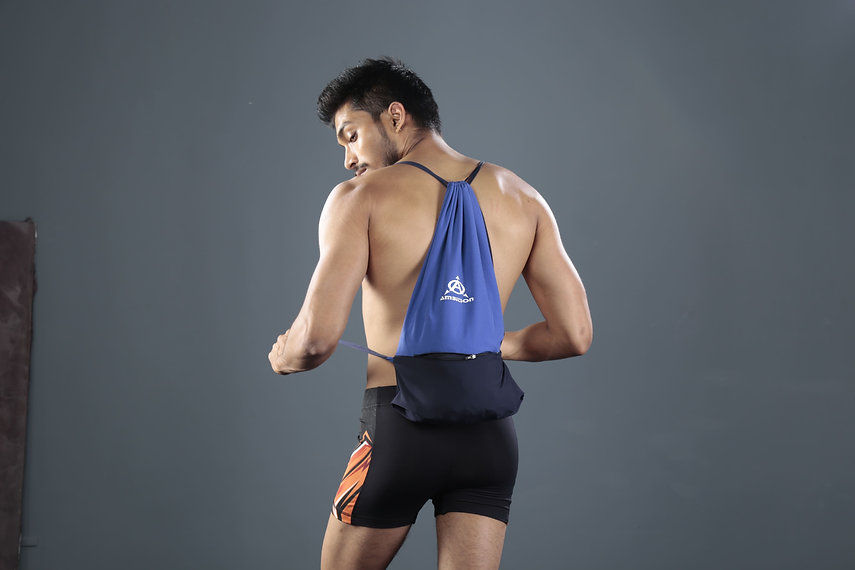 Man modeling blue drawstring bag