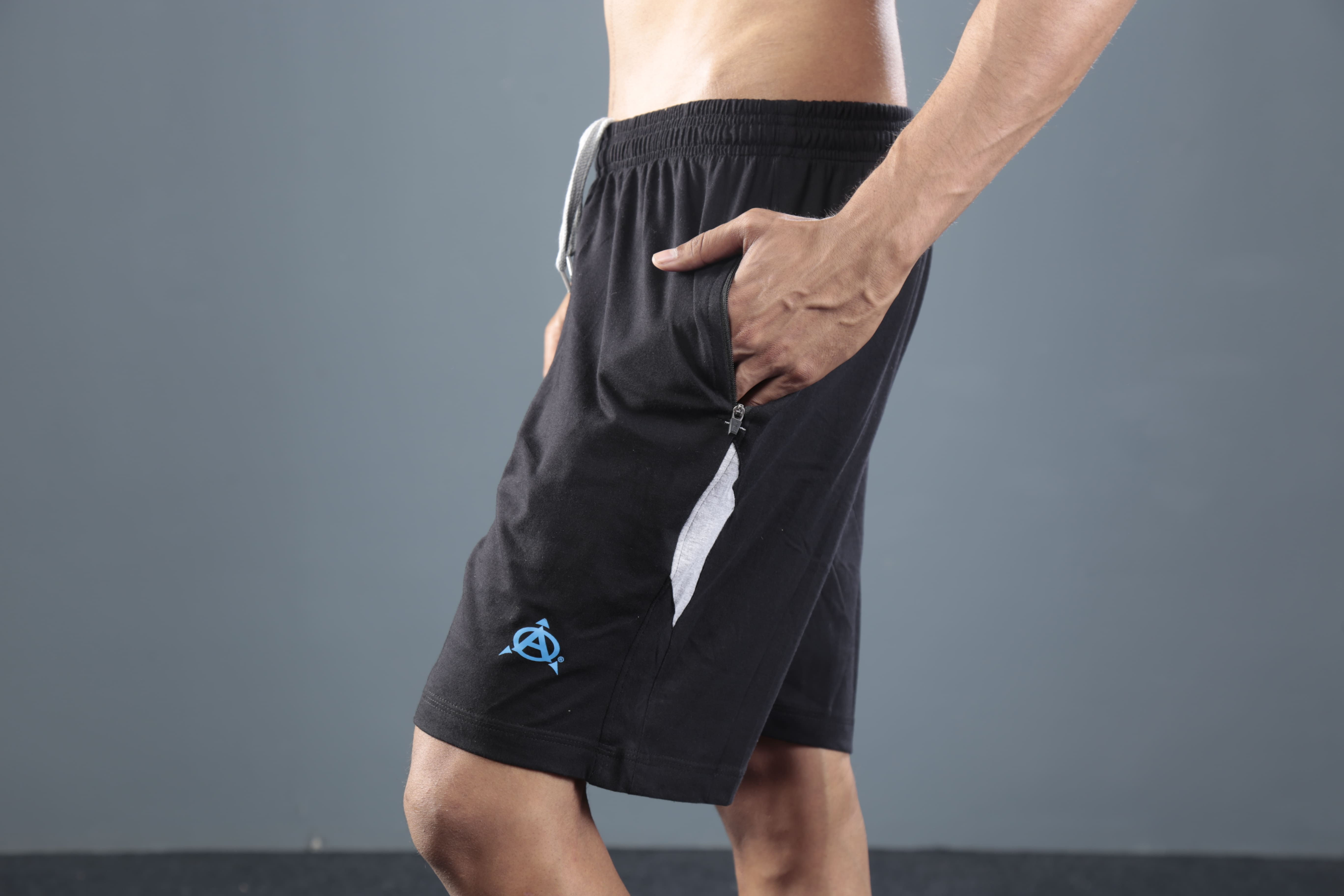 Man wearing black athletic shorts with side stripes