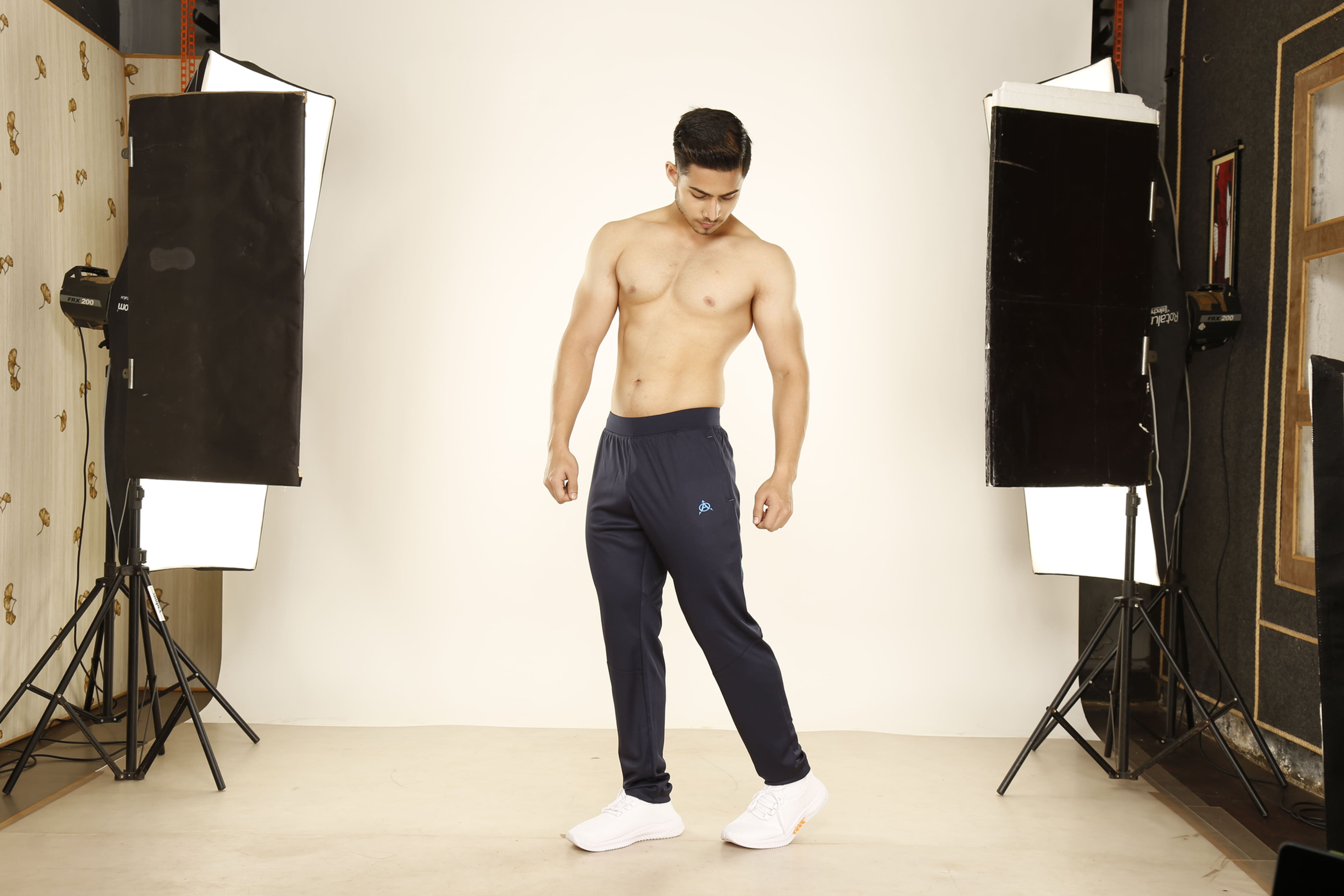 Man modeling navy blue athletic pants