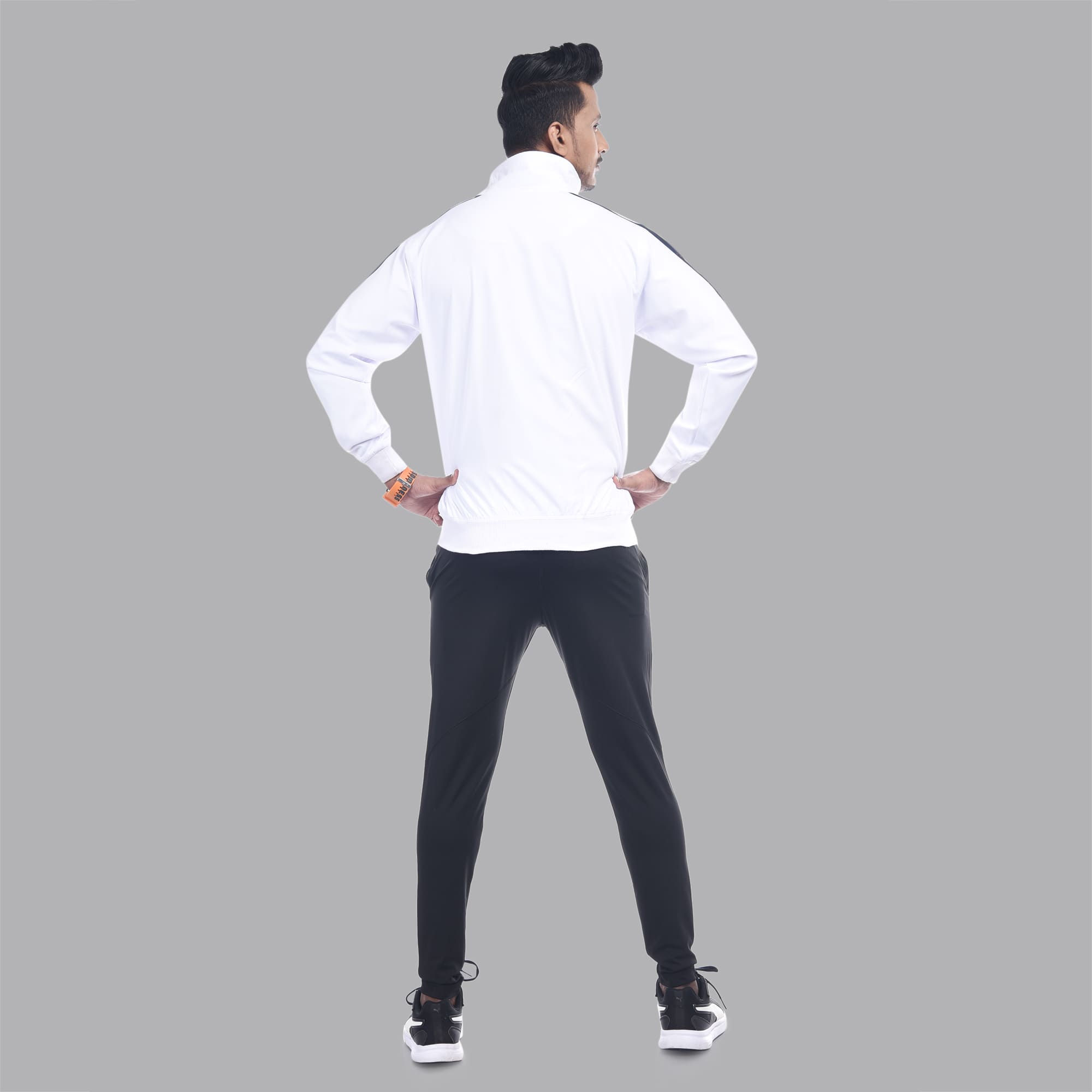 Man in white tracksuit, rear view