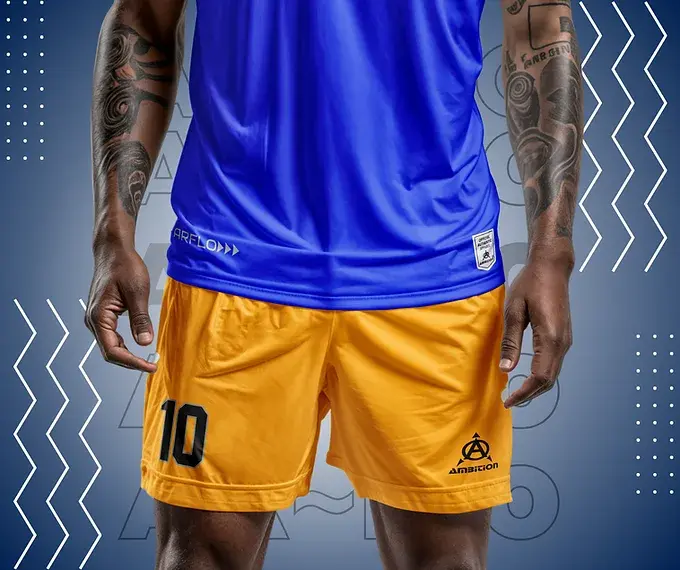 Person wearing gold soccer shorts and blue jersey
