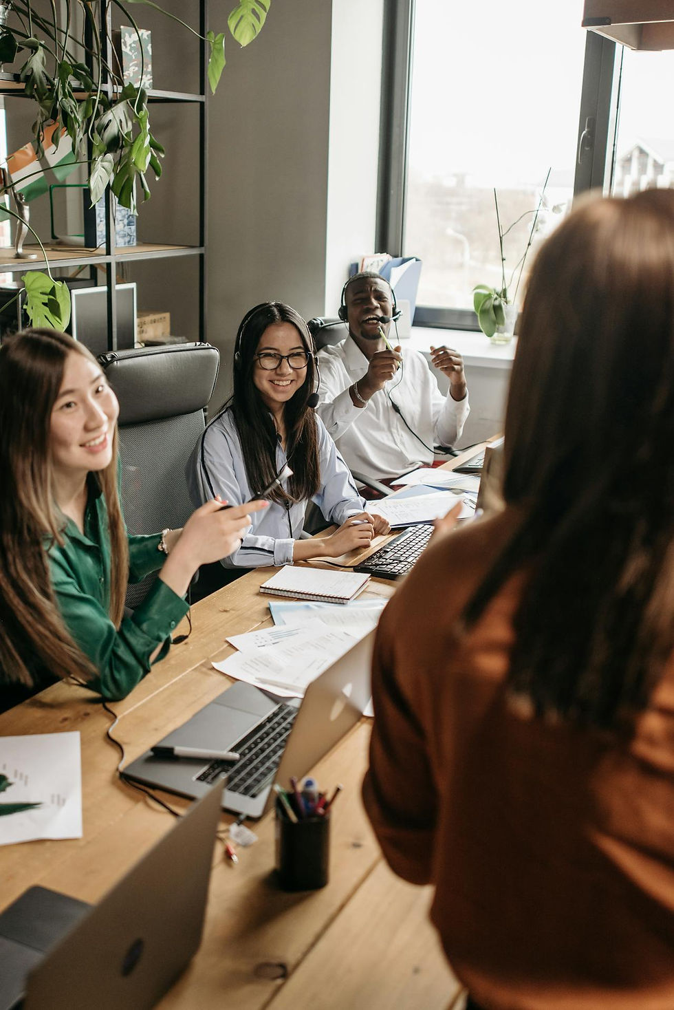 A woman executive speaking to her happy team