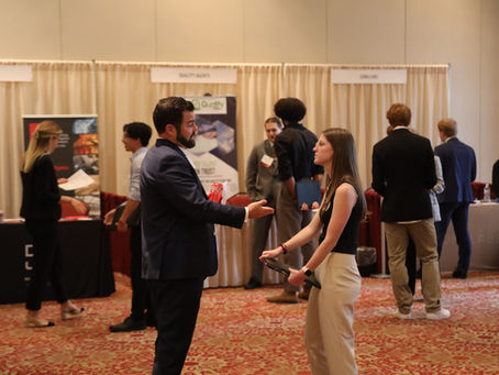A group of students talk at the career fair for biomedical engineering.